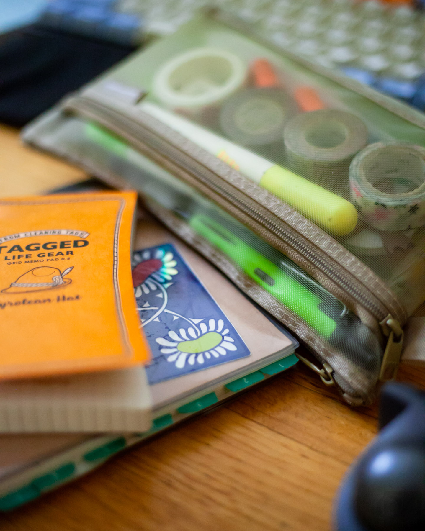 a close perspective view of notebooks and pencil case on a desk