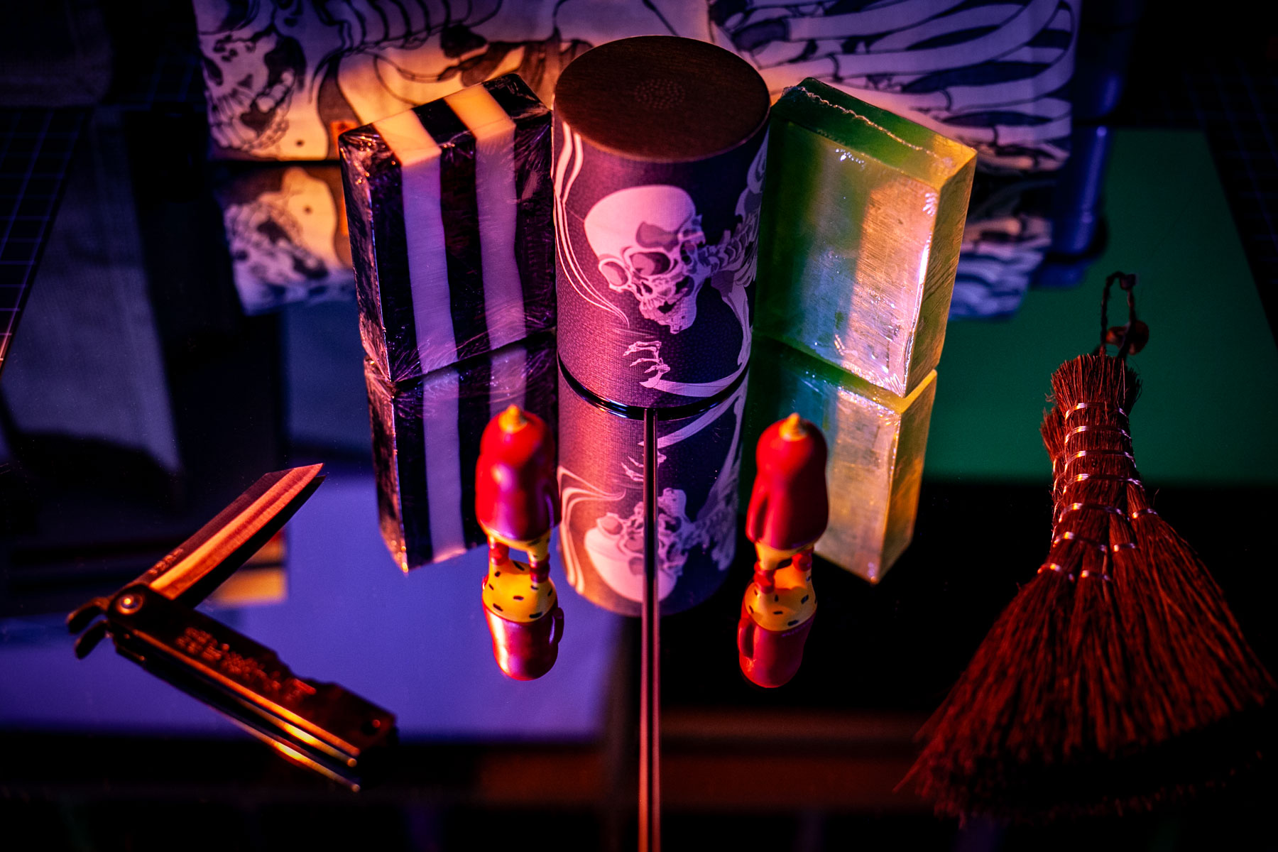 items arranged on mirror surface in eerie lighting