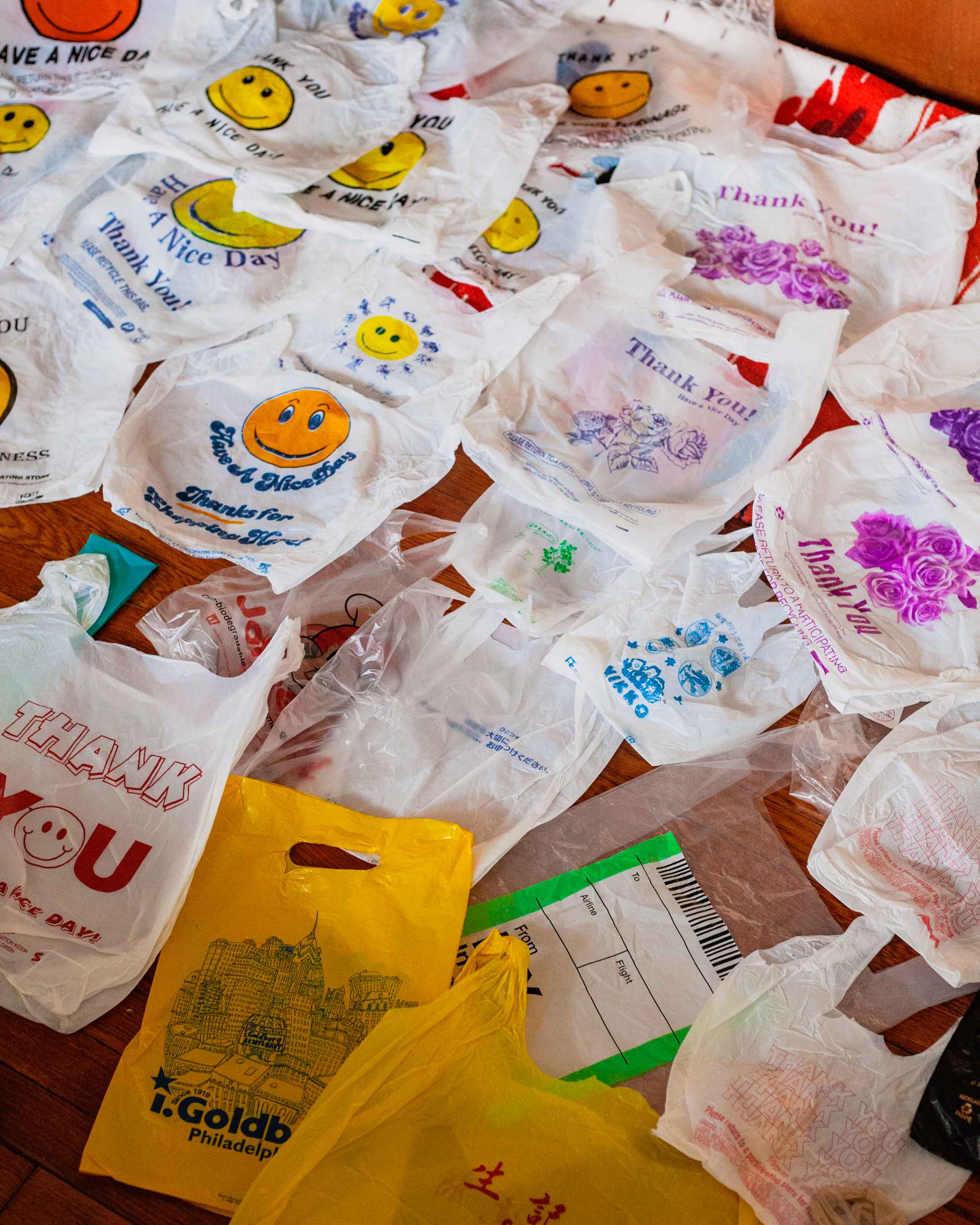 many plastic thank you bags flattened and spread across a floor